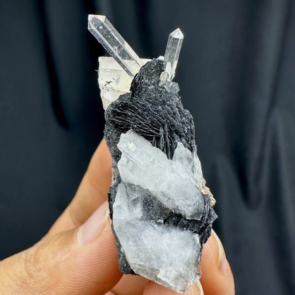 Clear quartz spire on black specular hematite plate from Guangdong, China, reverse side