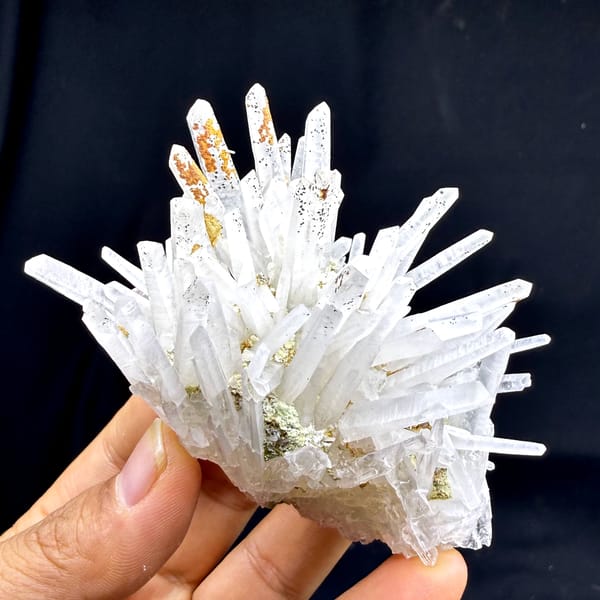 Starburst of white quartz needles with rust speckles from Guangdong, China, close-up of the crystal faces