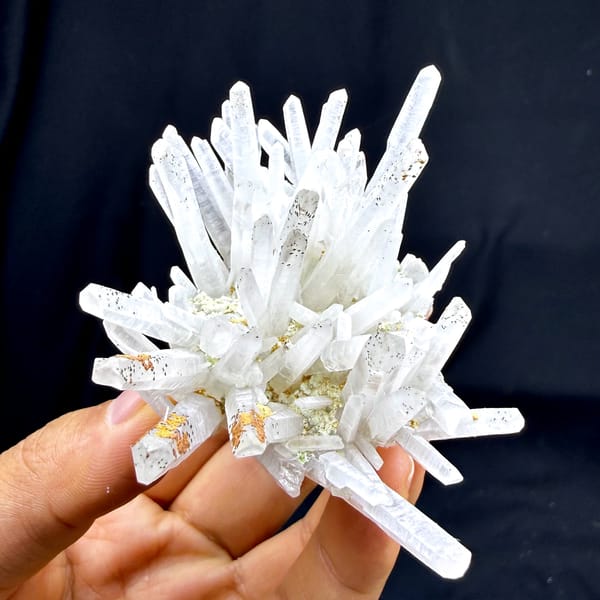 Starburst of white quartz needles with rust speckles from Guangdong, China, reverse side