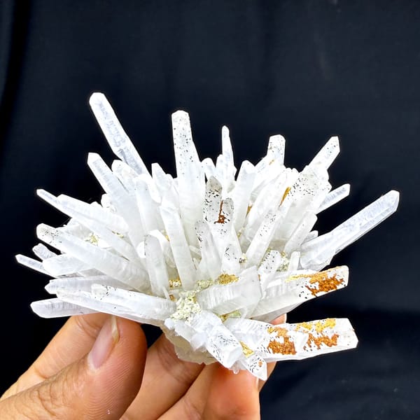 Starburst of white quartz needles with rust speckles from Guangdong, China, top view