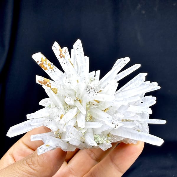 Starburst of white quartz needles with rust speckles from Guangdong, China, detail of the matrix contact