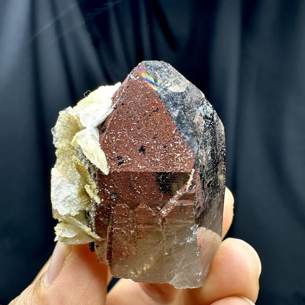 Red-skinned smoky quartz crystal with cream calcite from Yunxiao, Fujian, China, detail of the matrix contact