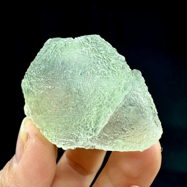 Pale green stepped fluorite with frosted skin from Guangdong, China, close-up of the crystal faces