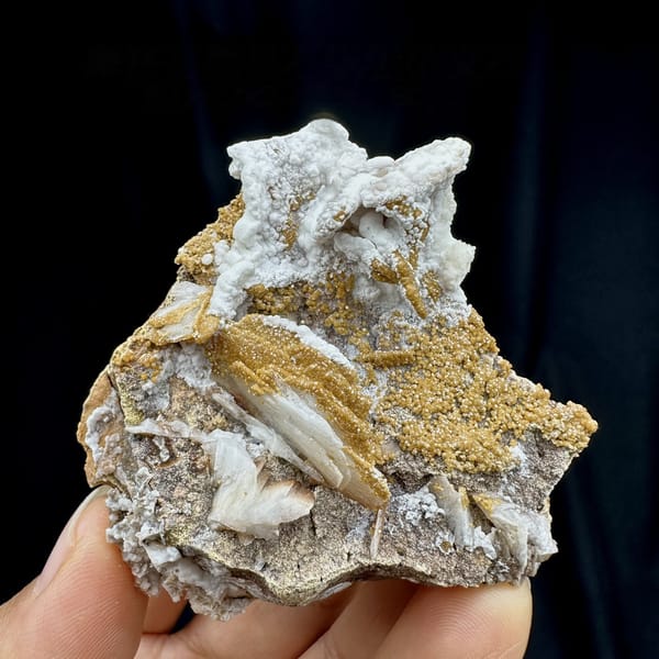 Tan baryte blades with vanadinite druse on white aragonite from Morocco, top view