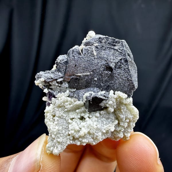 Black wolframite blades with purple fluorite and mica from Yaogangxian Mine, Hunan, China, detail of the matrix contact