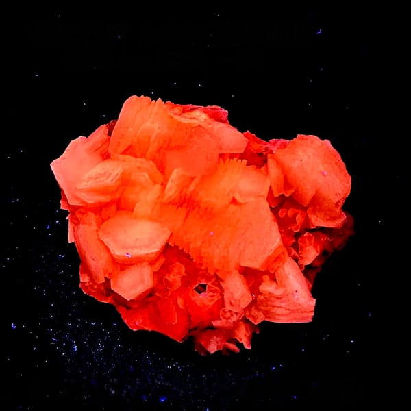 Hexagonal layered calcite fluorescing red under UV, from Yunxiao, Fujian, China