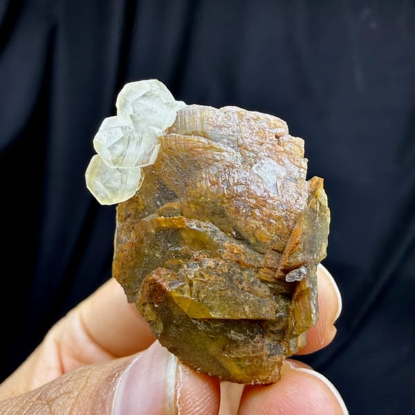 Golden-brown siderite block with pale calcite from Guizhou, China, held in hand