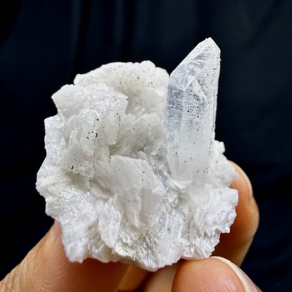 Clear quartz point on cream dolomite with pyrite from Guizhou, China, close-up of the crystal faces
