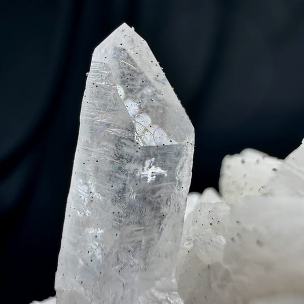 Clear quartz point on cream dolomite with pyrite from Guizhou, China, top view
