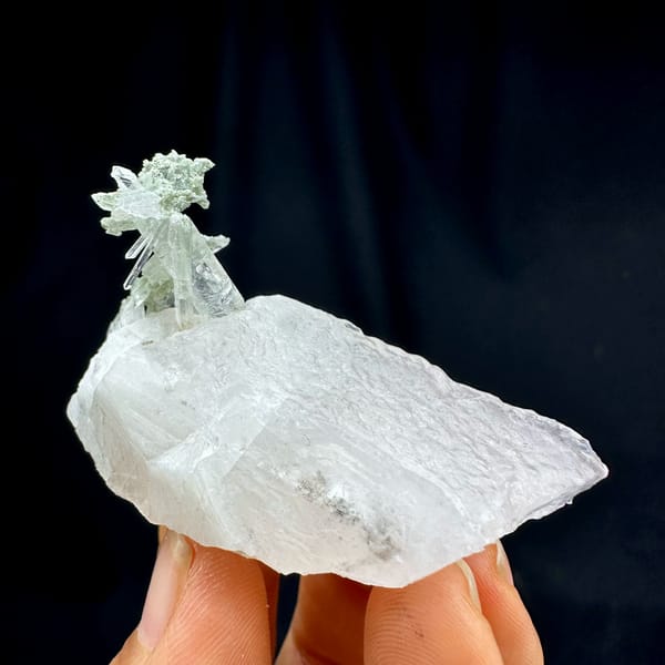 Calcite crystal with quartz, from Guangdong, China, front view in daylight, held in hand