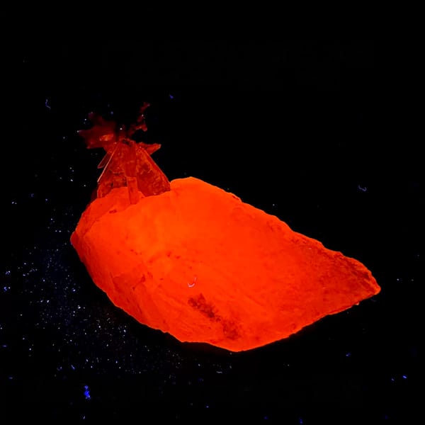 Calcite crystal with quartz fluorescing red-orange under UV, from Guangdong, China