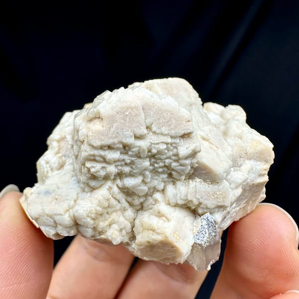 Blocky cream feldspar crystals with small quartz from Yunxiao, Fujian, China, close-up of the crystal faces