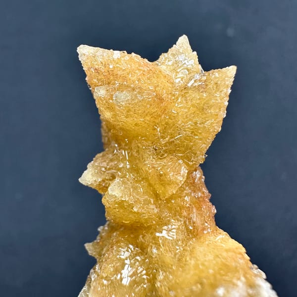 Golden double-terminated calcite branch from Guizhou, China, close-up of the crystal faces