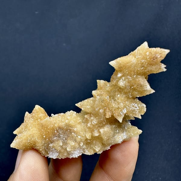 Golden double-terminated calcite branch from Guizhou, China, detail of the matrix contact