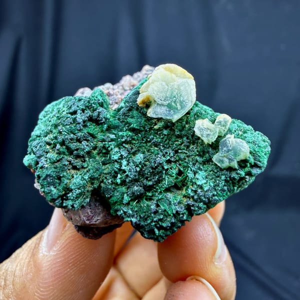 Deep green malachite crust with calcite and cobaltoan calcite from DR Congo, close-up of the crystal faces