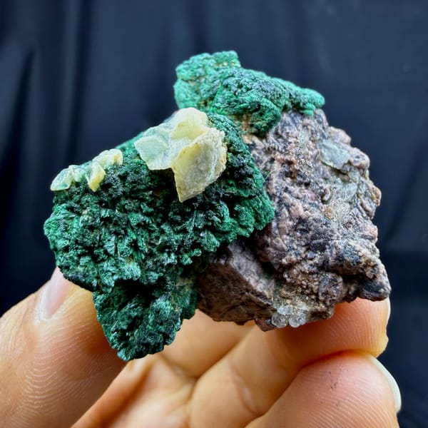Deep green malachite crust with calcite and cobaltoan calcite from DR Congo, top view