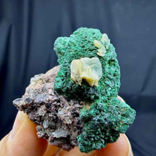 Deep green malachite crust with calcite and cobaltoan calcite from DR Congo, detail of the matrix contact