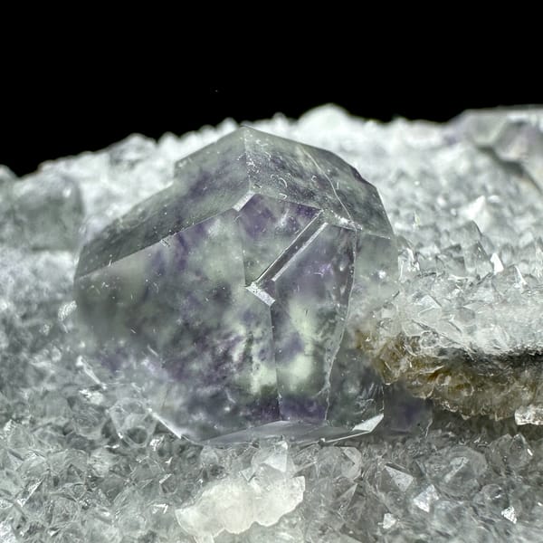 Transparent purple-zoned fluorite dodecahedron on white quartz from Fujian, China, second angle