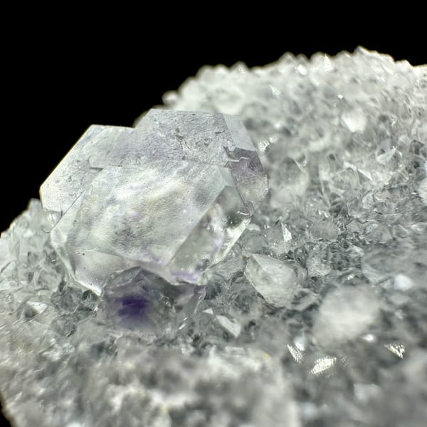 Transparent purple-zoned fluorite dodecahedron on white quartz from Fujian, China, reverse side
