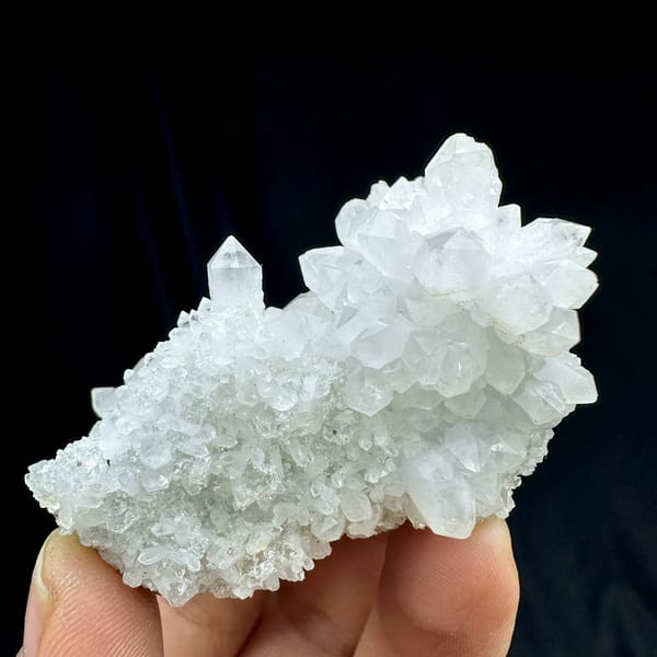 White quartz cluster with clear point and white fluorite from Guangdong, China, held in hand
