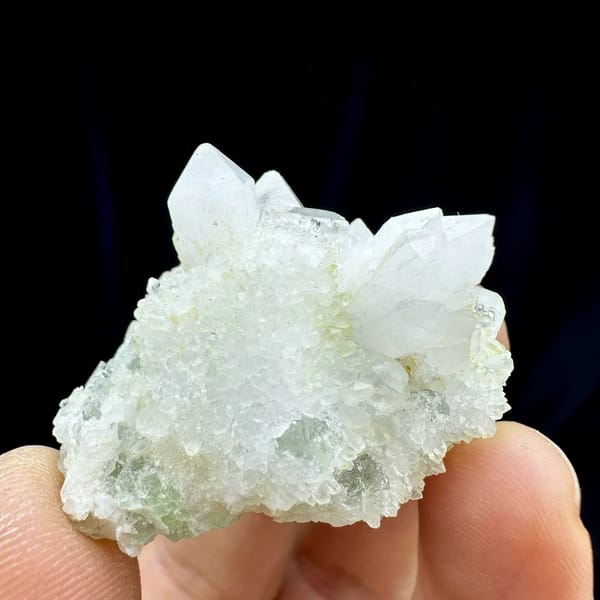 Clear quartz points with pale green fluorite from Guangdong, China, held in hand