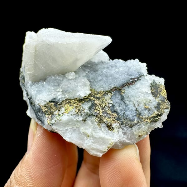 Sugar calcite with chalcopyrite, from Hunan, China, front view in daylight, held in hand