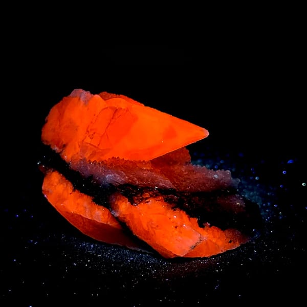 Sugar calcite with chalcopyrite fluorescing orange-red under UV, from Hunan, China