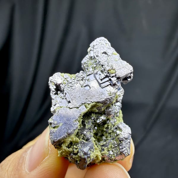 Etched galena cube on green-crusted matrix from Inner Mongolia, China, detail of the matrix contact