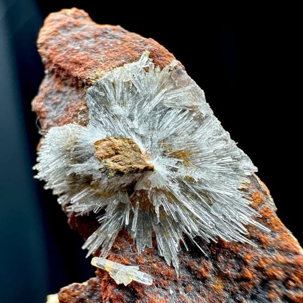White acicular creedite spray on rust-red wedge from Guizhou, China, second angle
