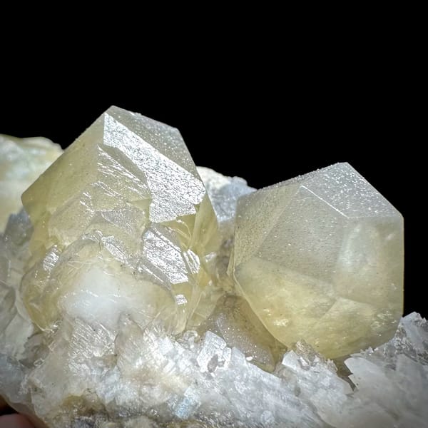 Pale yellow-green calcite rhombs with cream dolomite from Fujian, China, close-up of the crystal faces