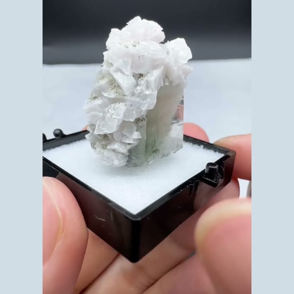 Green quartz crystal capped with white dolomite — detail view