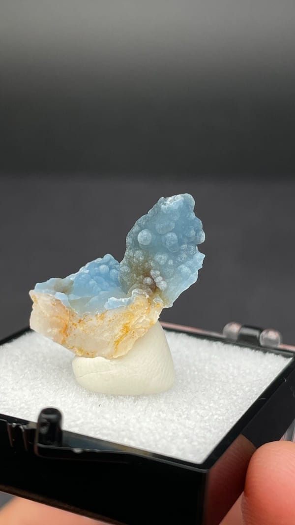 Sky-blue botryoidal plumbogummite on orange-tan matrix from Guangxi, China, second angle