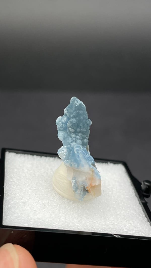 Sky-blue botryoidal plumbogummite on orange-tan matrix from Guangxi, China, close-up of the crystal faces