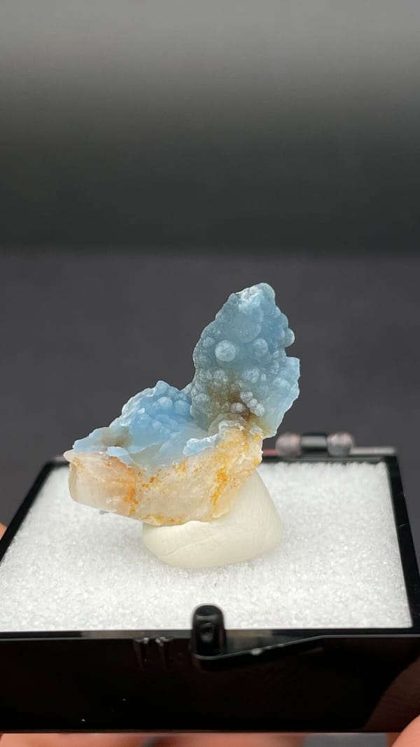 Sky-blue botryoidal plumbogummite on orange-tan matrix from Guangxi, China, reverse side