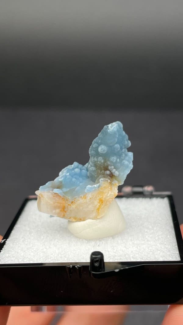 Sky-blue botryoidal plumbogummite on orange-tan matrix from Guangxi, China, detail of the matrix contact