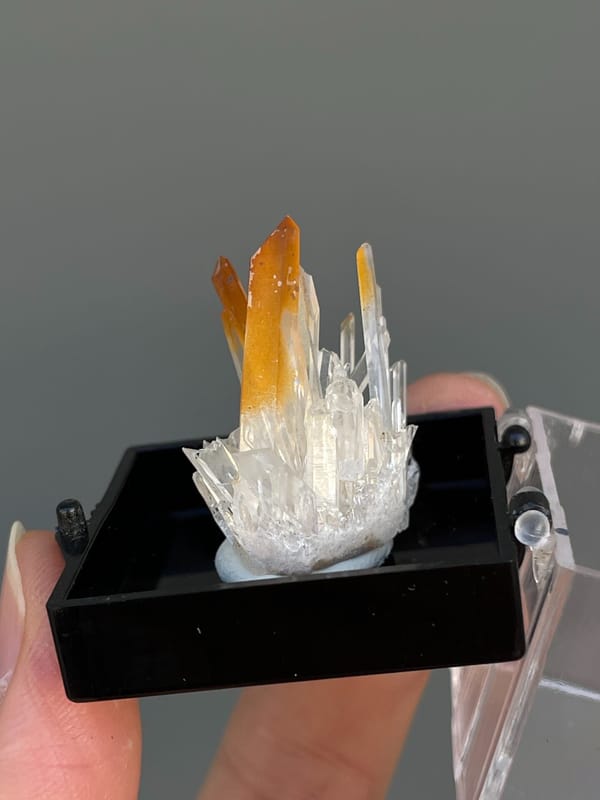 Amber quartz points rising from a white crystal base, Jinkouhe, Sichuan, China, detail of the matrix contact