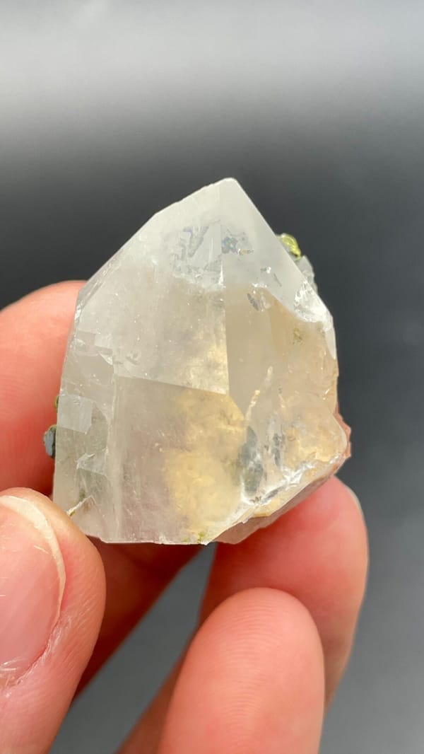 Clear quartz crystal with small green epidote inclusions from Meigu, Sichuan