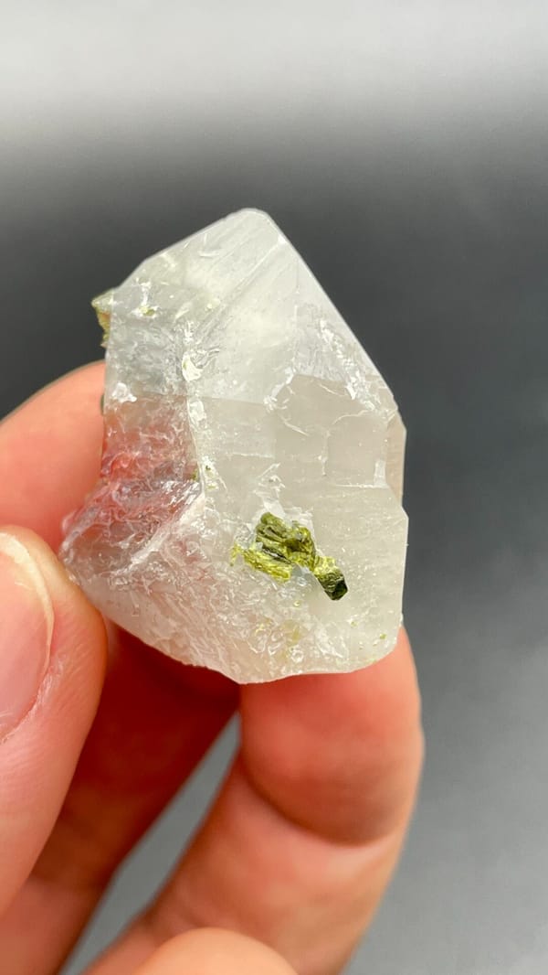 Clear quartz crystal with small green epidote inclusions from Meigu, Sichuan, reverse side