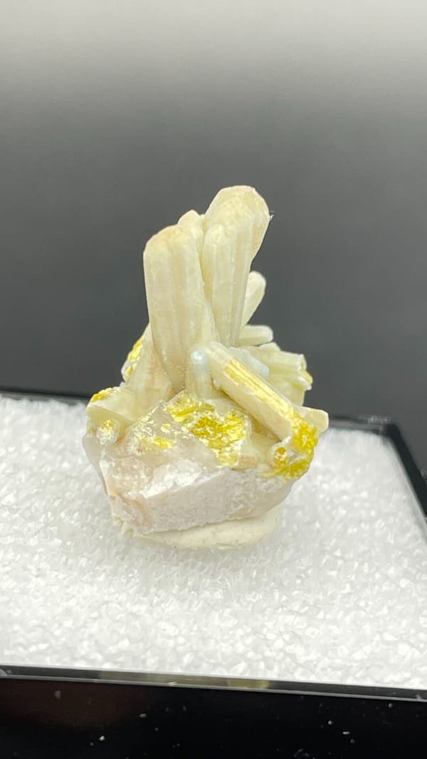 Cream-green plumbogummite prisms with yellow at the base, Guangxi, China, detail of the matrix contact