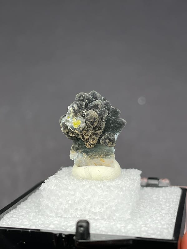 Grey-green botryoidal plumbogummite ball cluster from Guangxi, China, in a box