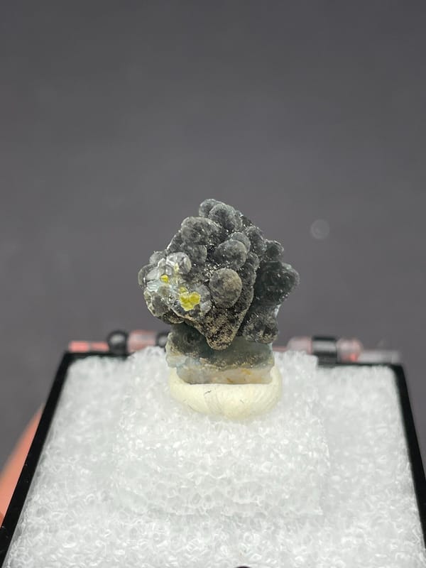 Grey-green botryoidal plumbogummite ball cluster from Guangxi, China, in a box, reverse side