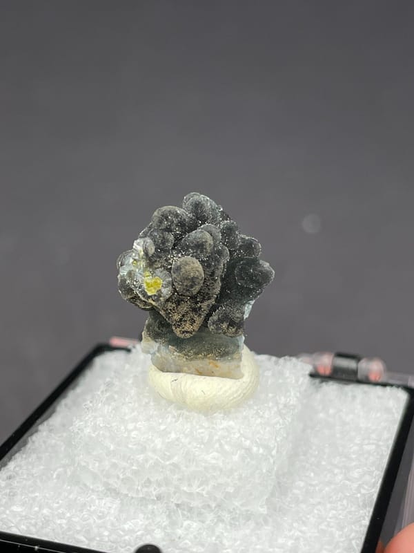 Grey-green botryoidal plumbogummite ball cluster from Guangxi, China, in a box, top view