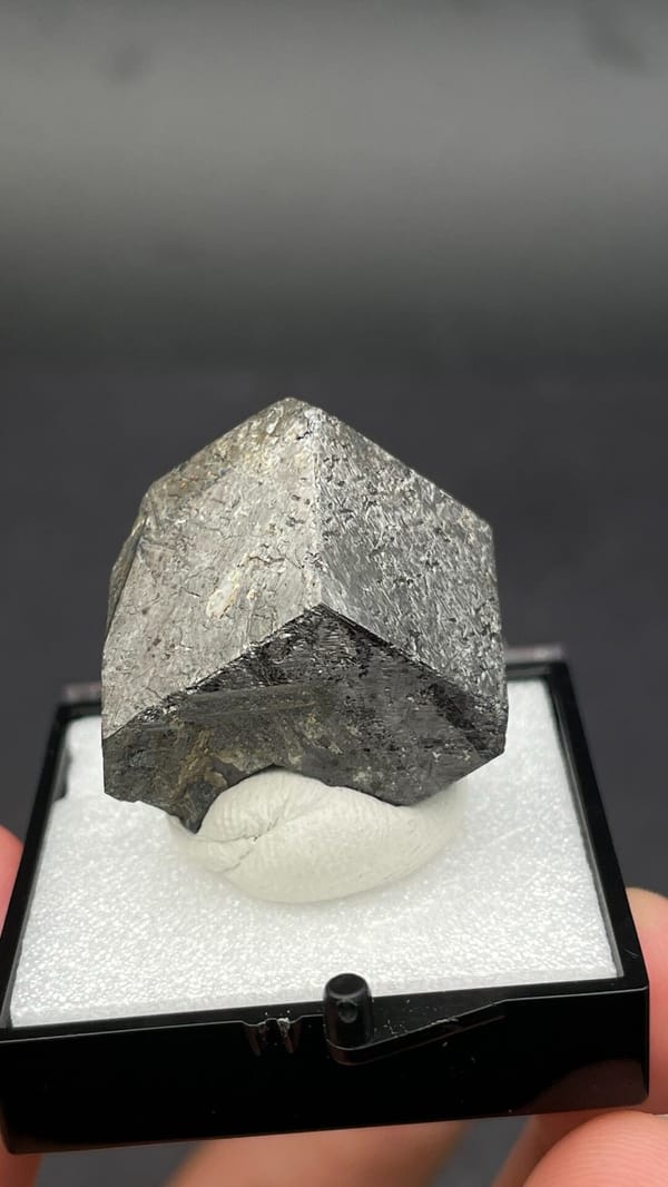 Dark steel-grey magnetite single crystal from Inner Mongolia, China, in a box, reverse side