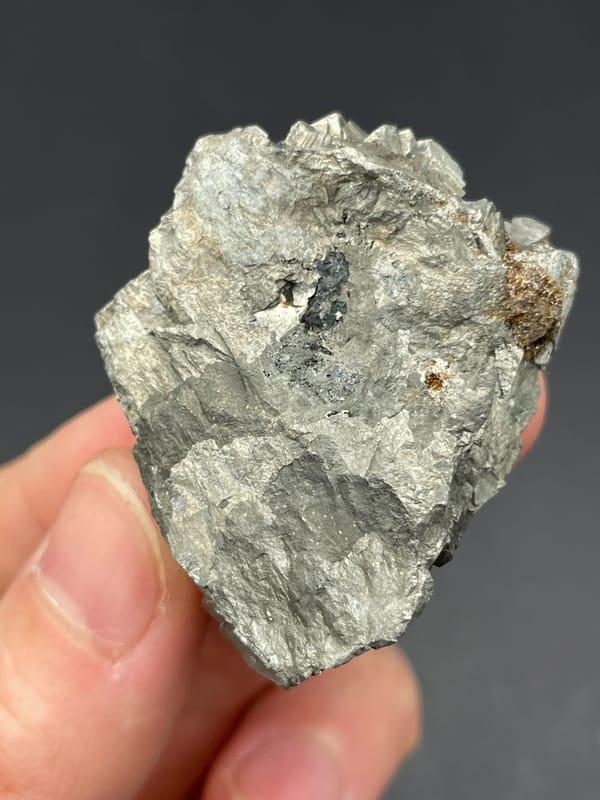 Silvery metallic arsenopyrite crystal group from Yaogangxian, Hunan, China, detail of the matrix contact