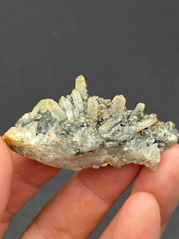 Dark metallic bismuthinite with pale quartz crystals, Inner Mongolia, China, second angle
