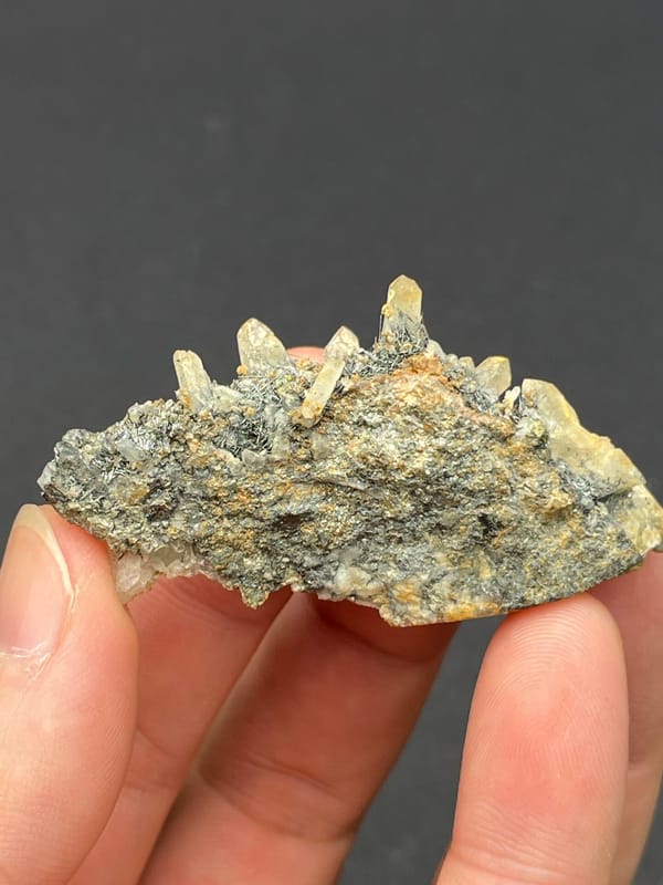 Dark metallic bismuthinite with pale quartz crystals, Inner Mongolia, China, reverse side