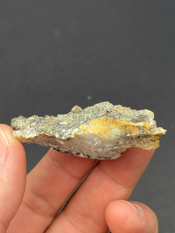 Dark metallic bismuthinite with pale quartz crystals, Inner Mongolia, China, top view