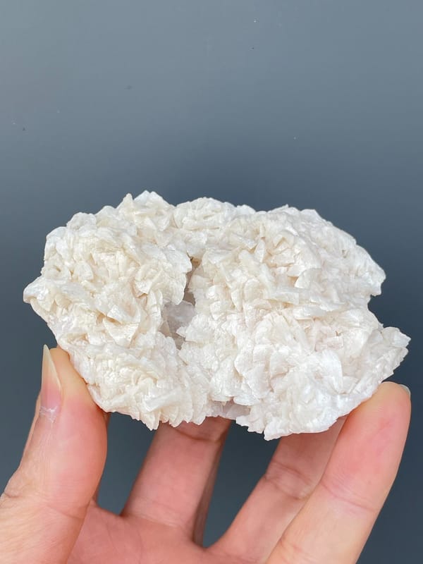 Plate covered in white platy dolomite rosettes from Hunan, China, close-up of the crystal faces