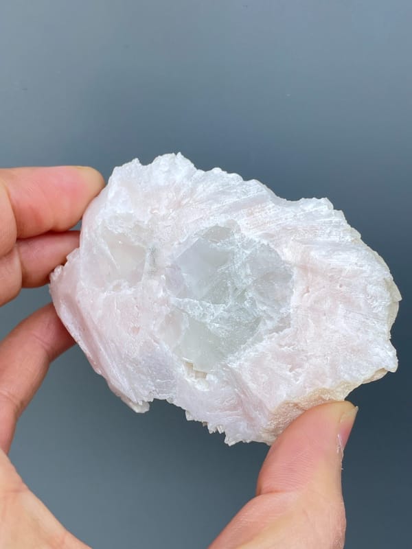 Plate covered in white platy dolomite rosettes from Hunan, China, detail of the matrix contact