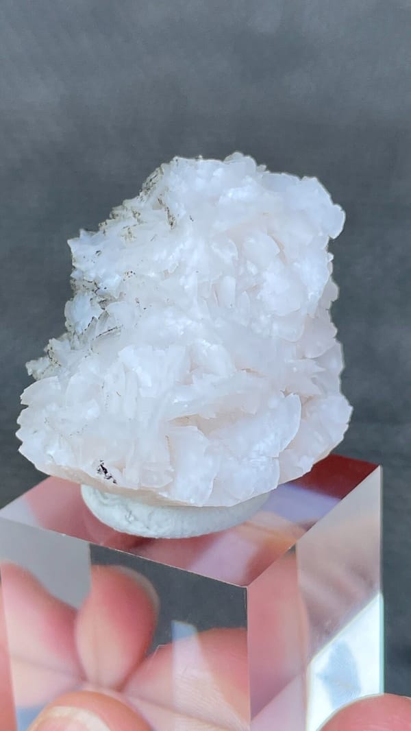 White dolomite crystal rosette with dark pyrite from Hunan, China, close-up of the crystal faces